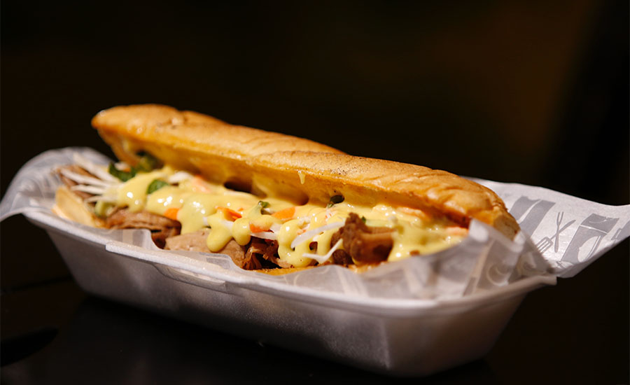 Photo of two hot dogs served on a paper plate