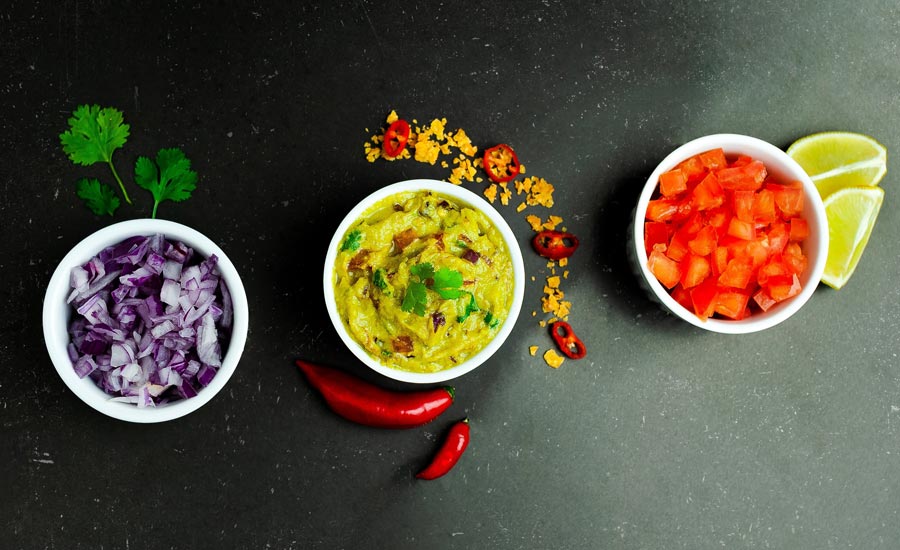Bowl with guacamole red onion and tomato